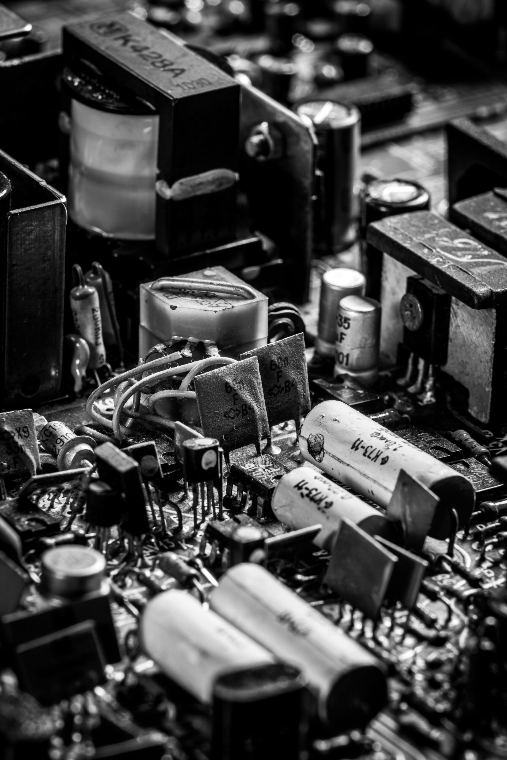 Detailed black and white image showcasing electronic circuit board components with capacitors and resistors.
